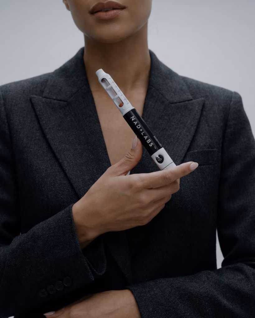 Professional woman holding NAD+ Labs Pen