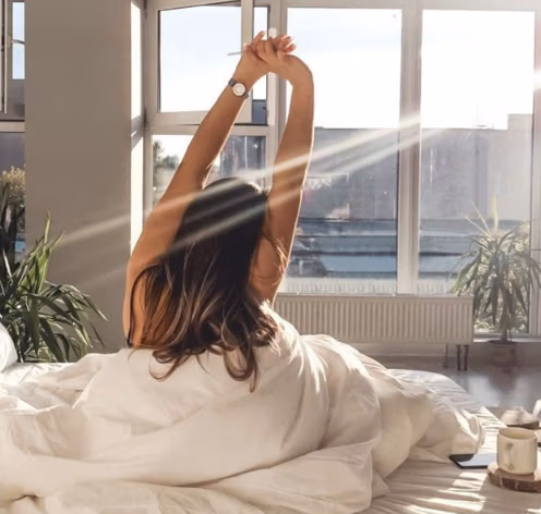 Person feeling energized with molecular energy particles representing increased NAD⁺ levels